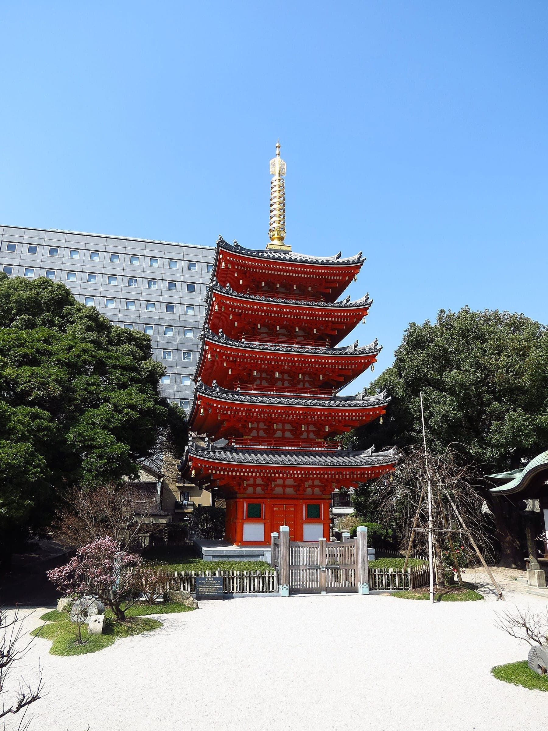 The red five-storey pagoda of Tocho-ji stands over a raked gravel court a short walk from Hakata Station.