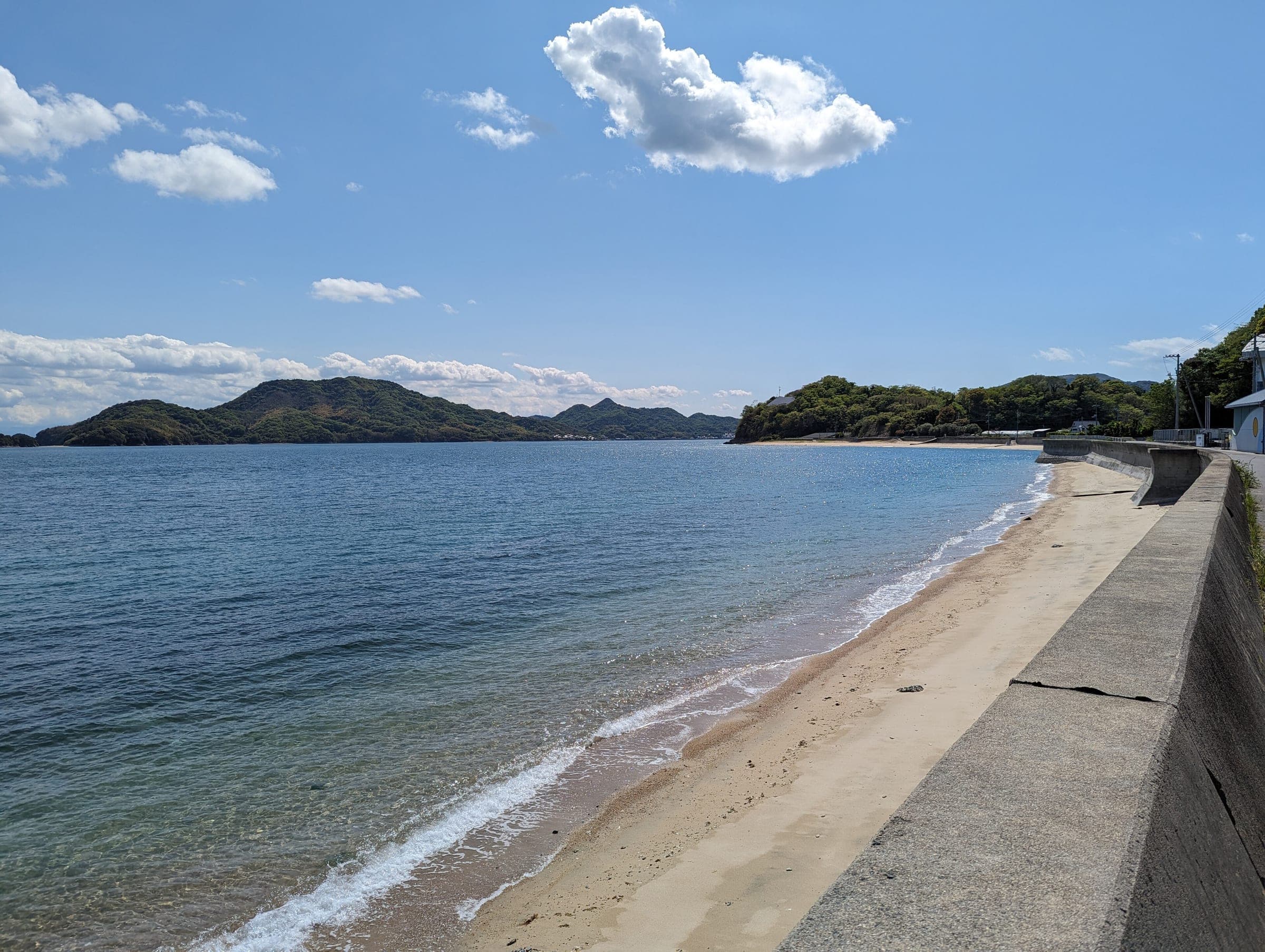 A quiet sand beach on Hakatajima looks out over calm water to neighbouring islands.