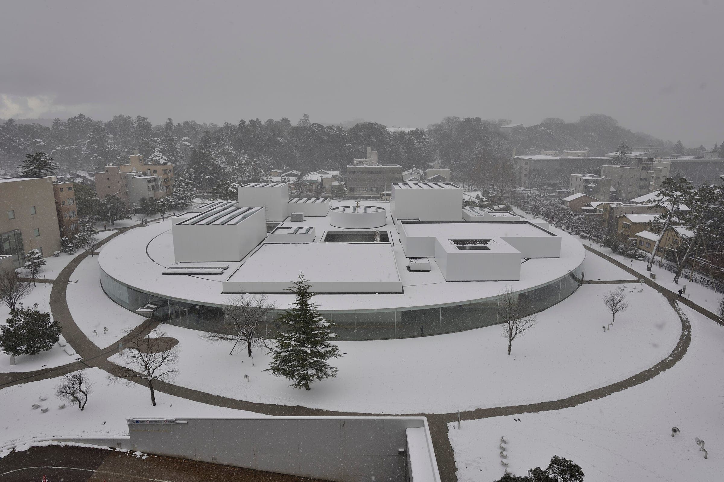 Snow covers the round 21st Century Museum of Contemporary Art and its lawns in central Kanazawa