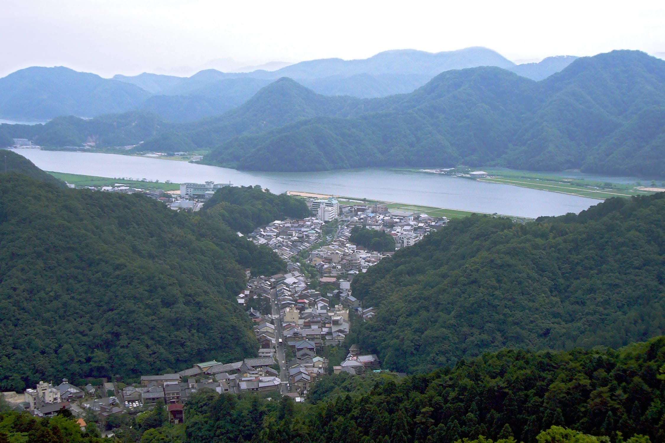 Kinosaki Onsen fills the narrow valley below Mount Daishi, and the Maruyama River widens beyond it