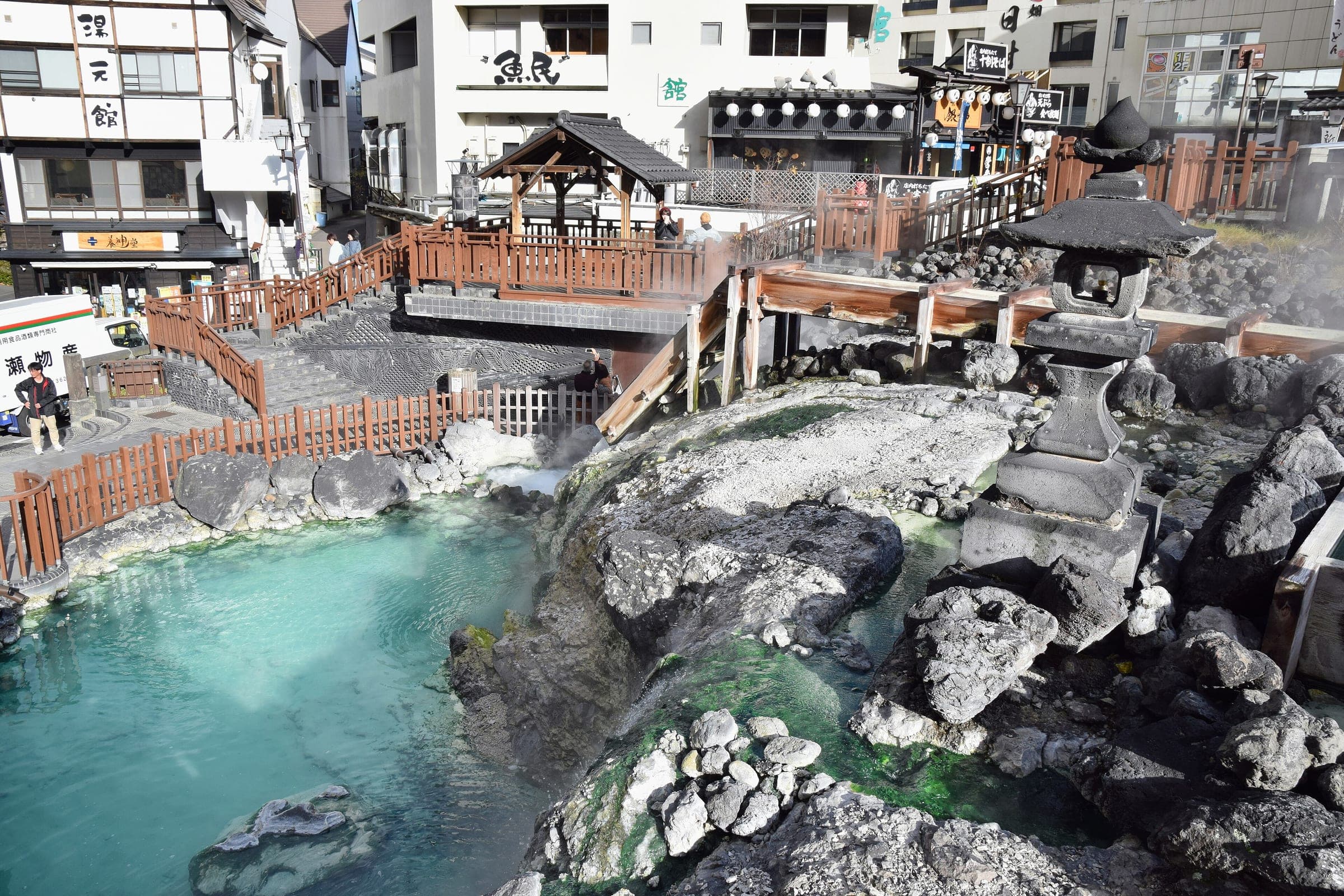 Blue spring water pools below the Yubatake's wooden walkways in the centre of Kusatsu Onsen