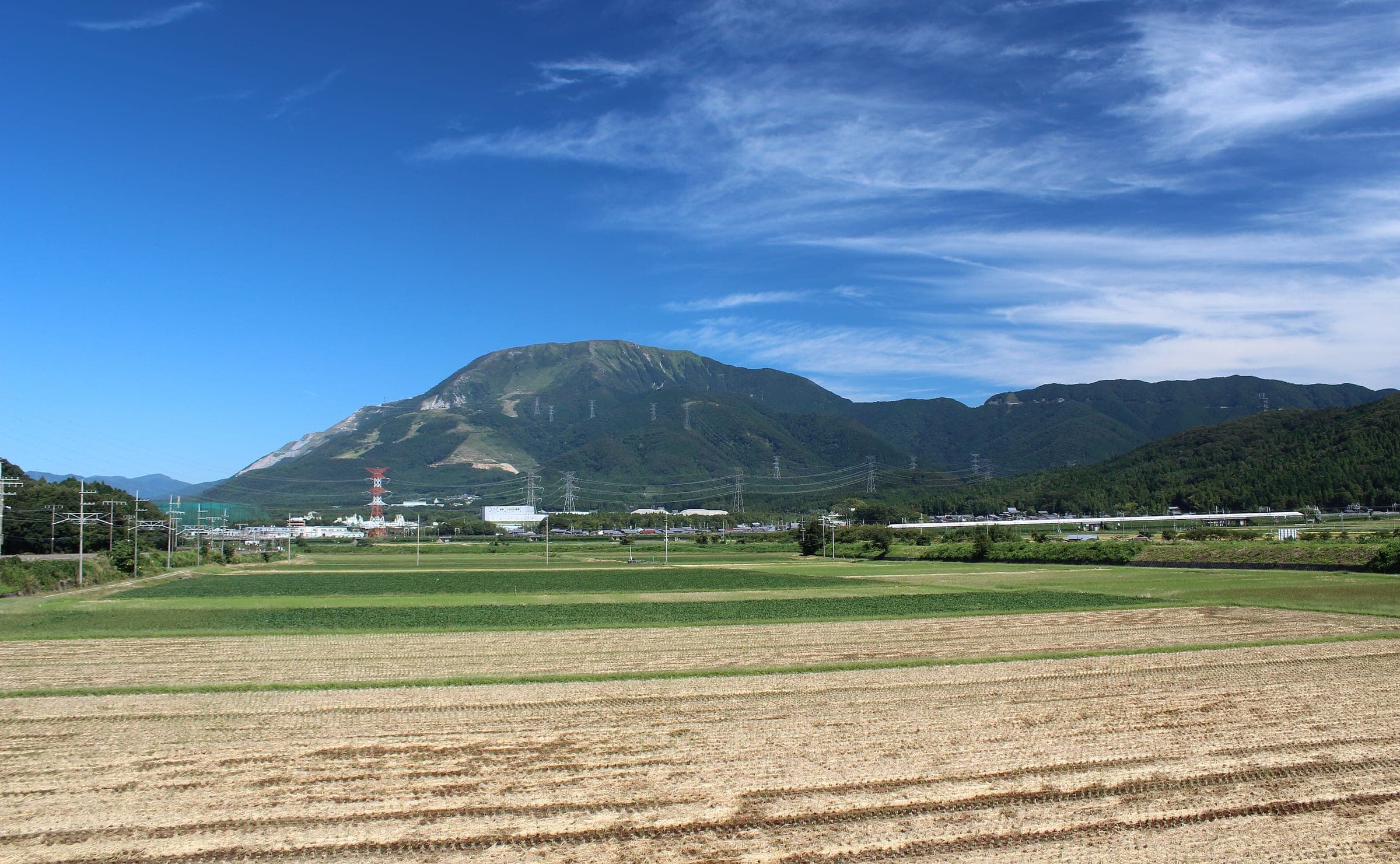 Mount Ibuki rises over harvested fields at Kashiwabara in Maibara under a blue September sky