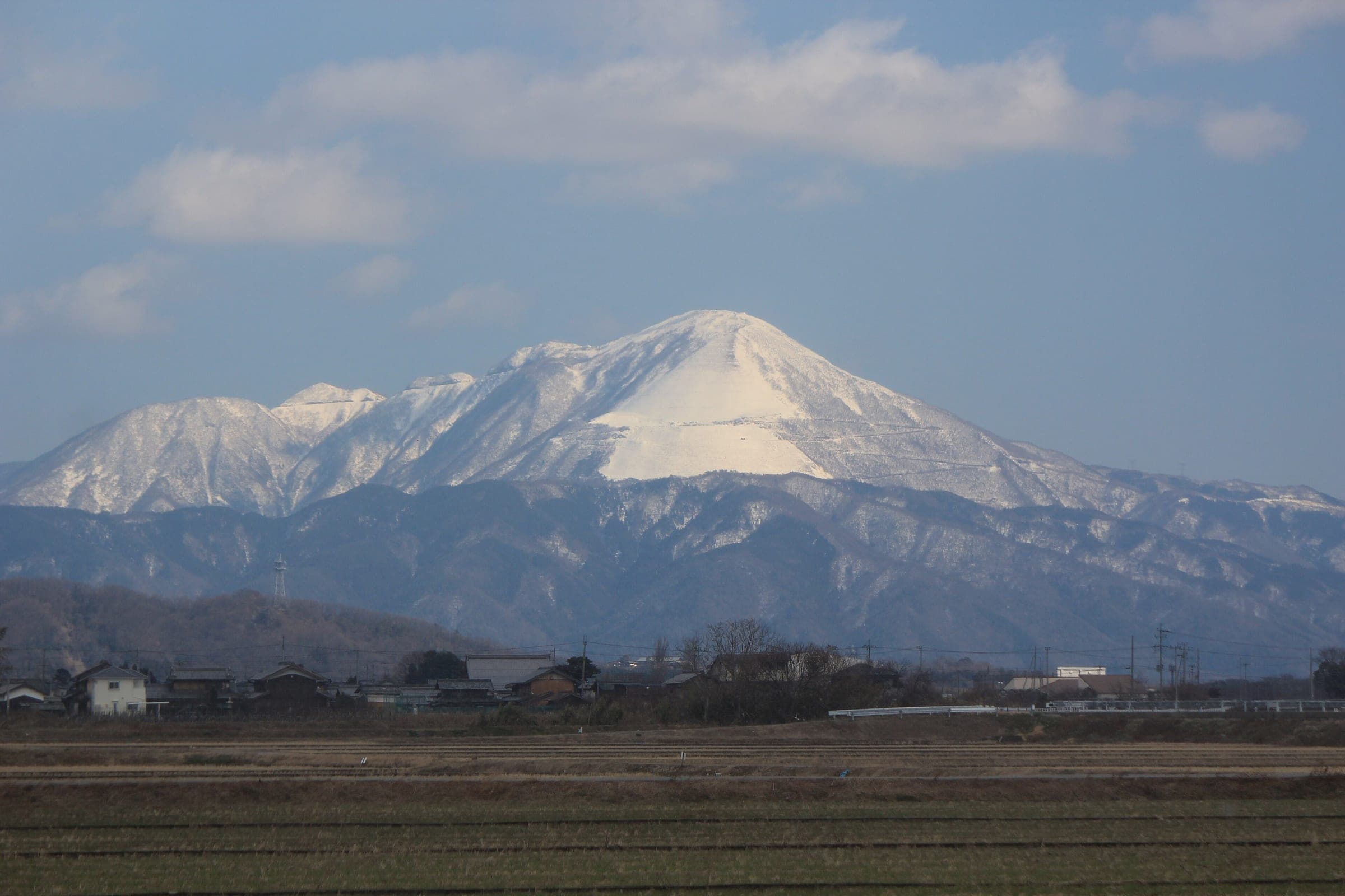 Snow covers Mount Ibuki above the farmland of northern Shiga in February