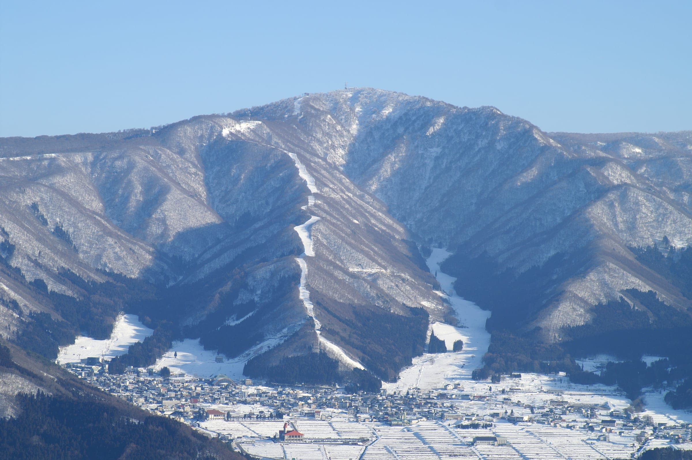Nozawa Onsen village sits under the snowy ski runs of Mount Kenashi in January.