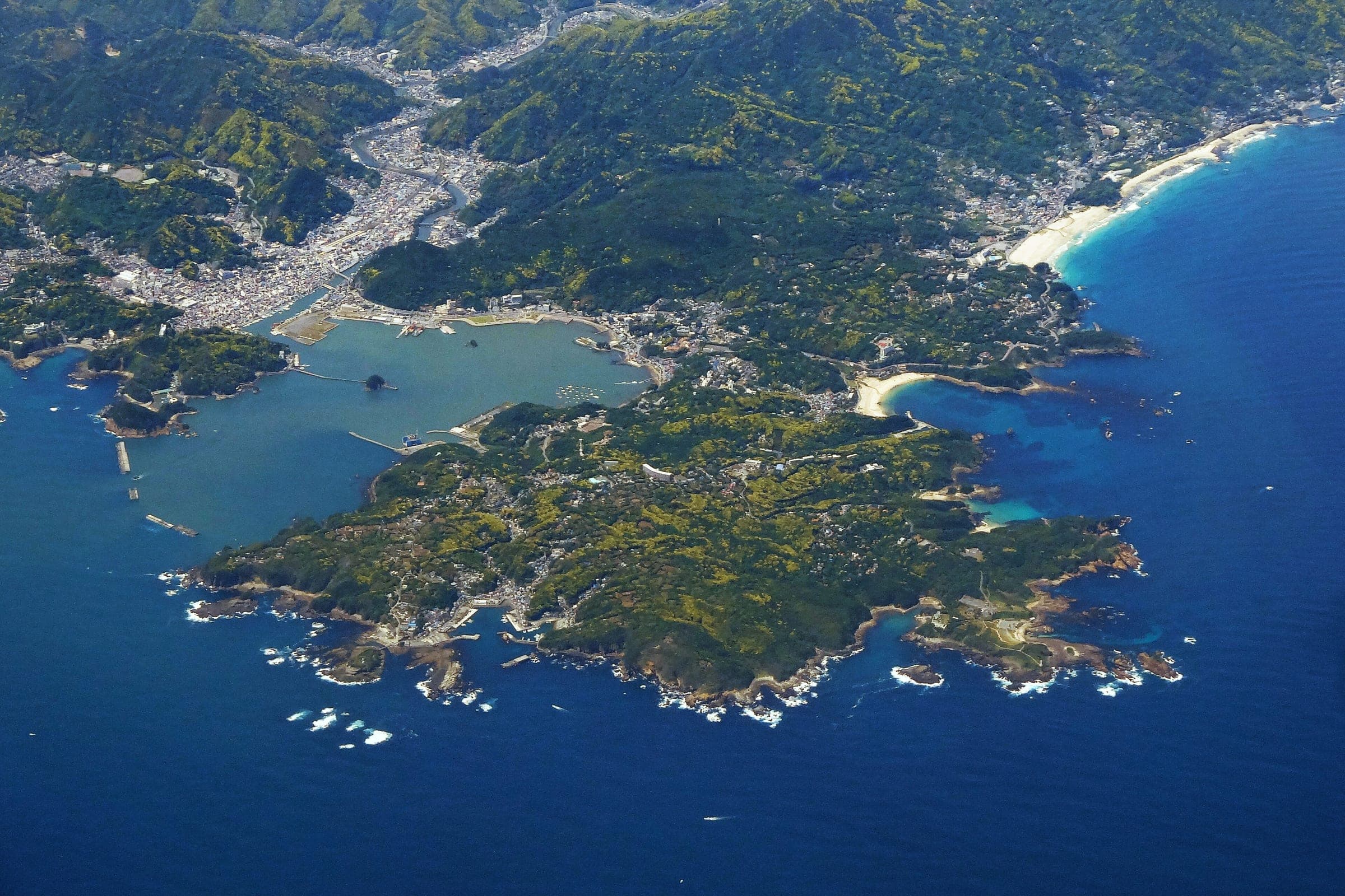 Shimoda's harbour, town and white beaches spread around Cape Tsumeki in this view from the air.