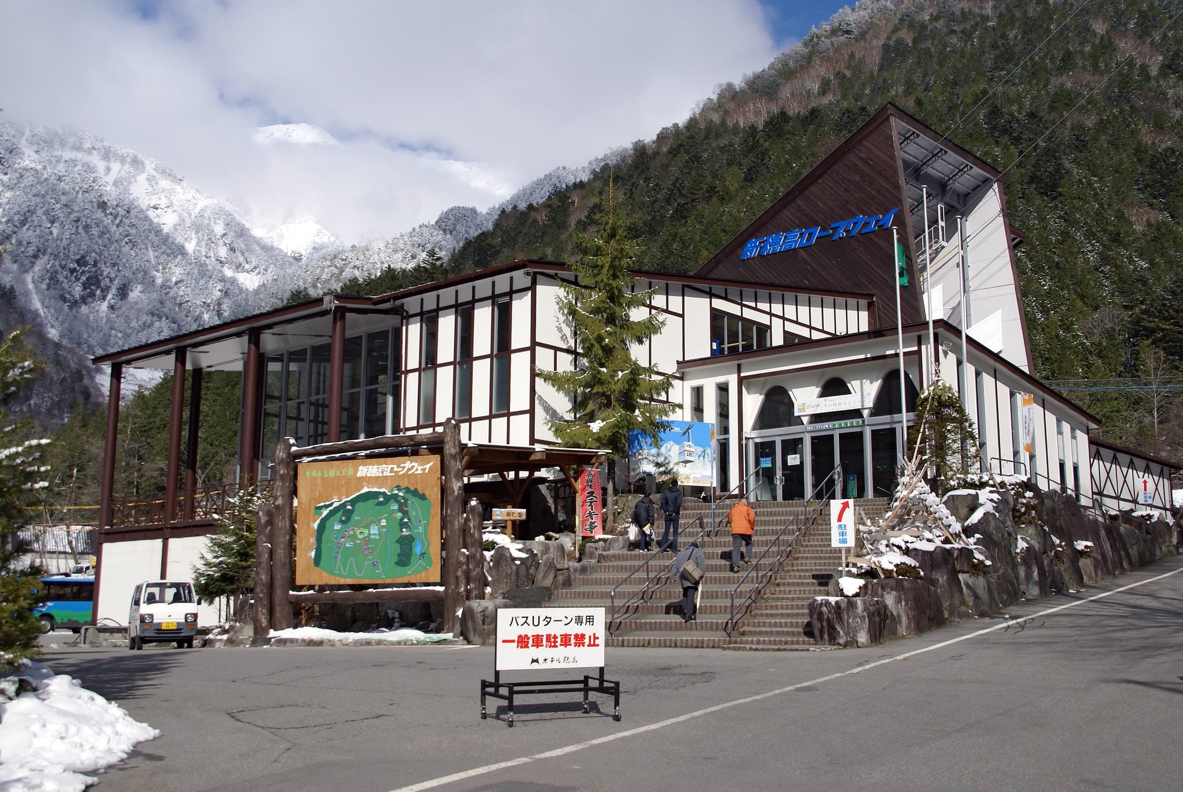 Snowy peaks rise behind Shin-Hotaka Onsen station at the foot of the Shin-Hotaka Ropeway