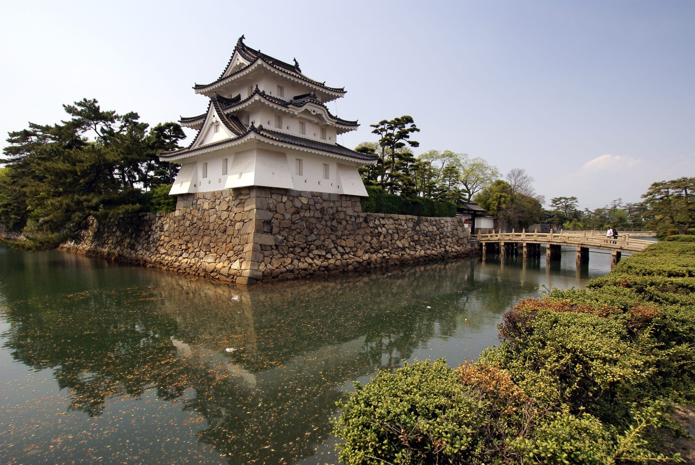 The Tsukimi turret of Takamatsu Castle reflects in its seawater moat at Tamamo Park.