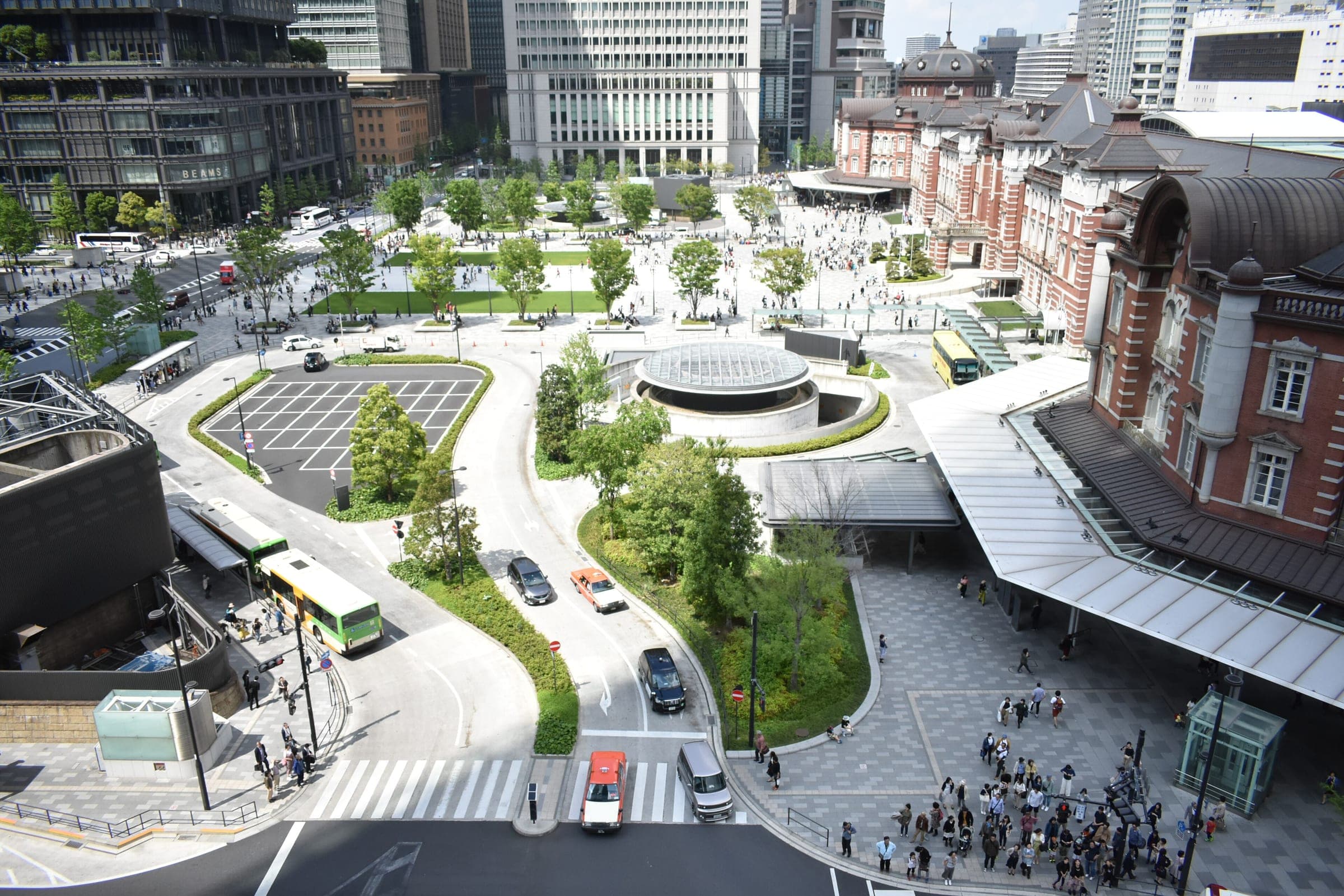 Taxis and buses circle the plaza before the red-brick Marunouchi side of Tokyo Station.