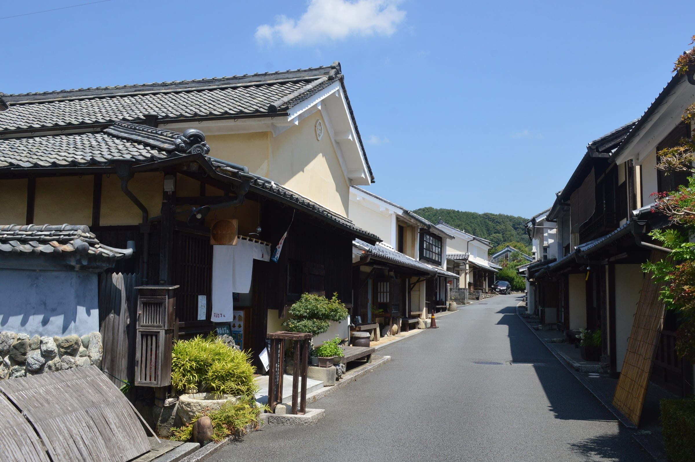 Plaster-walled merchant houses line the quiet main street of Yokaichi Gokoku in Uchiko.