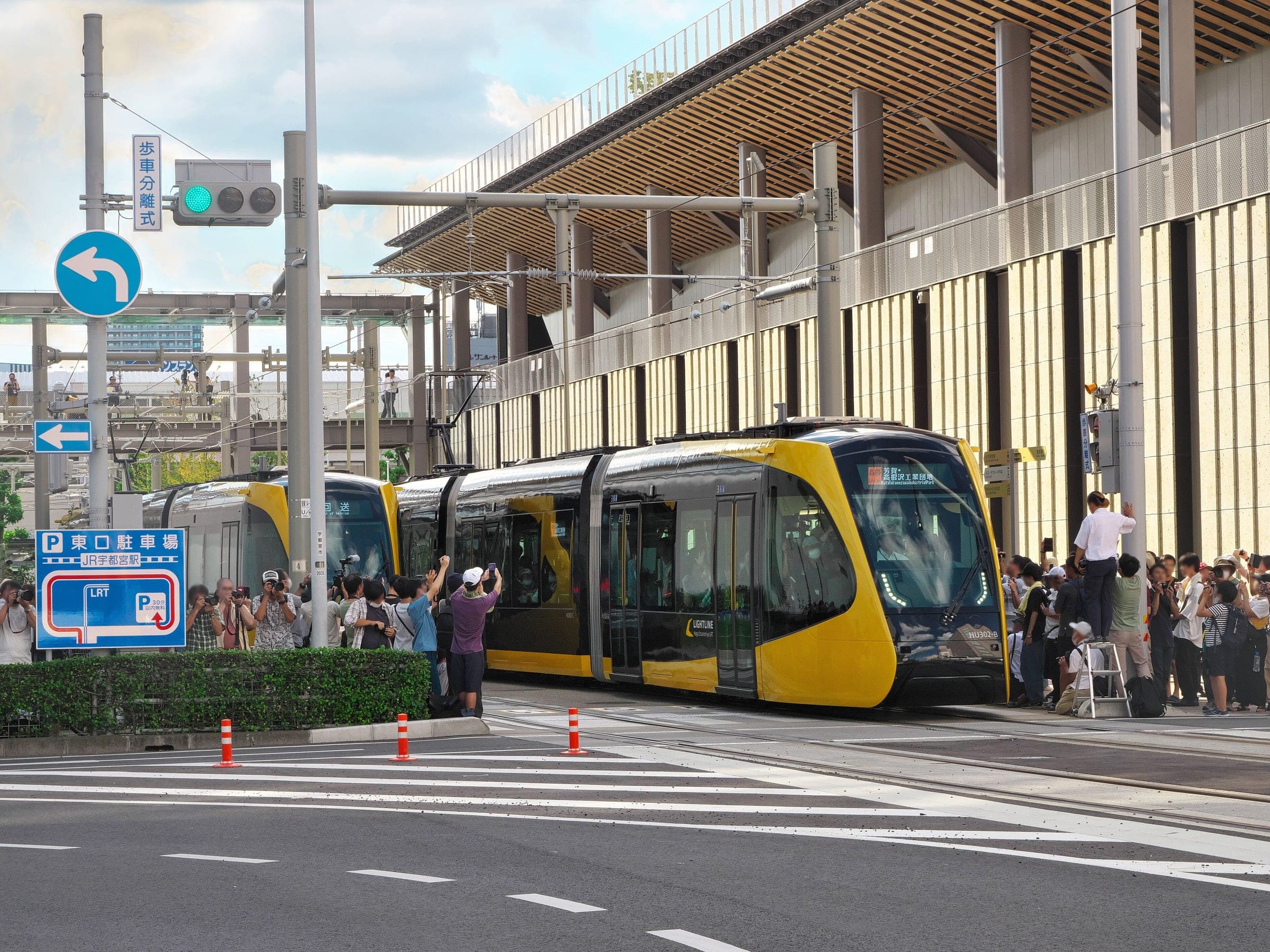 A yellow Utsunomiya Light Rail tram waits at the east exit of Utsunomiya Station